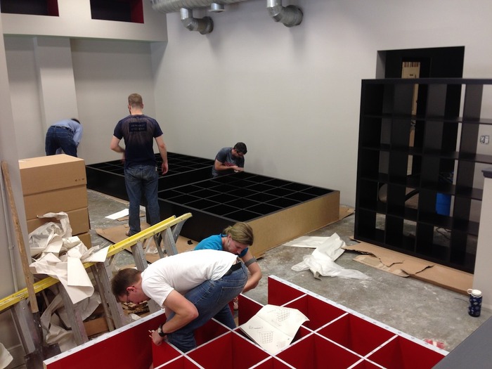 Spielbound volunteers building the heavy shelves